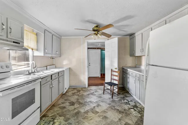 a kitchen with a sink stove and refrigerator
