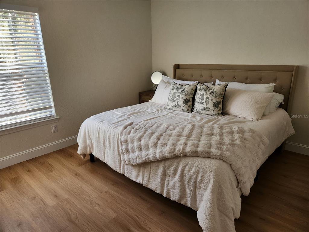 8926 Manor Loop, Unit 201B Lakewood Ranch, FL 34202 - Photo 18 of 32 a bedroom with bed and a window