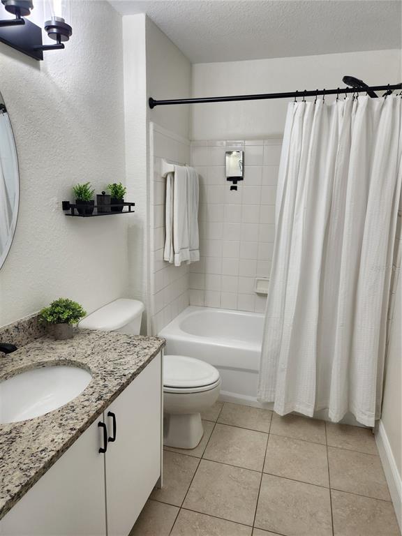 8926 Manor Loop, Unit 201B Lakewood Ranch, FL 34202 - Photo 20 of 32 a bathroom with a granite countertop sink and a mirror