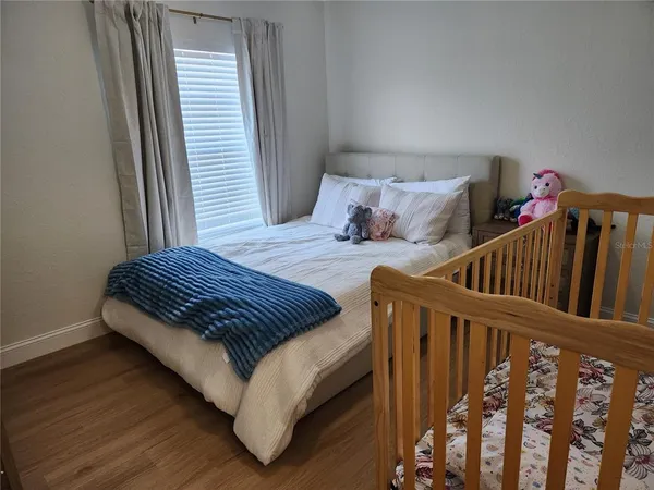 a bedroom with furniture and baby crib