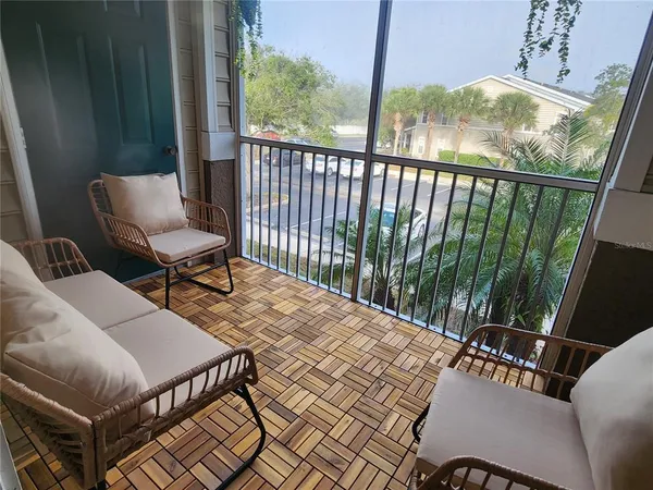 a balcony with table and chairs