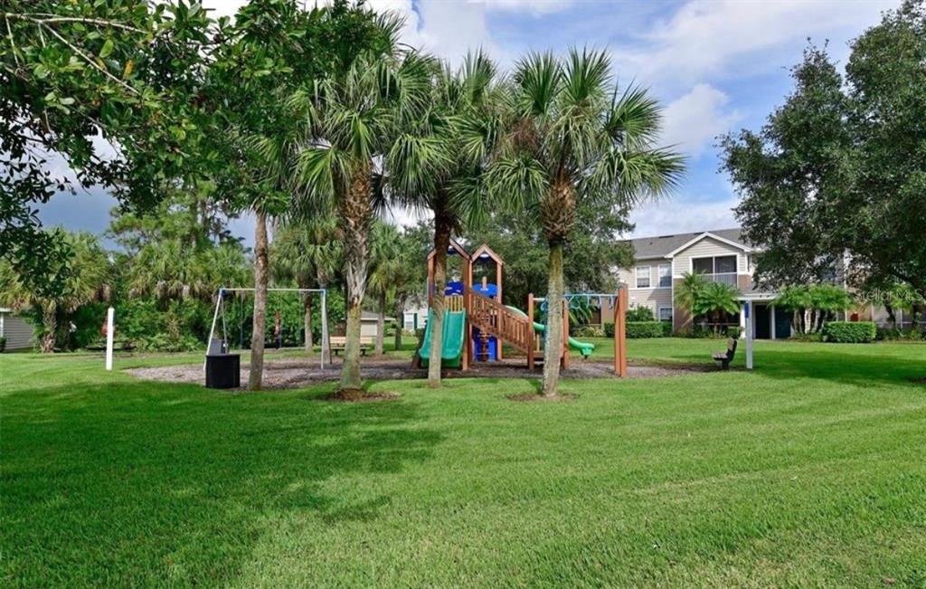 8926 Manor Loop, Unit 201B Lakewood Ranch, FL 34202 - Photo 30 of 32 a view of a park with large trees and plants