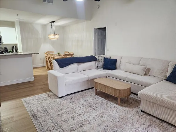 a living room with furniture and wooden floor