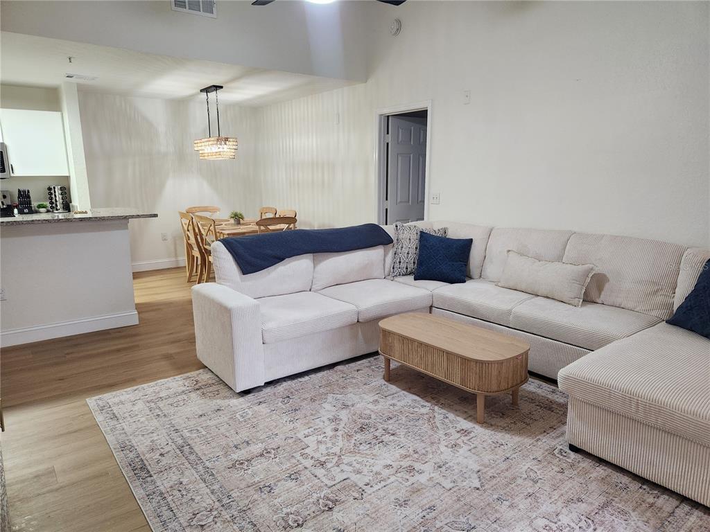 8926 Manor Loop, Unit 201B Lakewood Ranch, FL 34202 - Photo 5 of 32 a living room with furniture and wooden floor