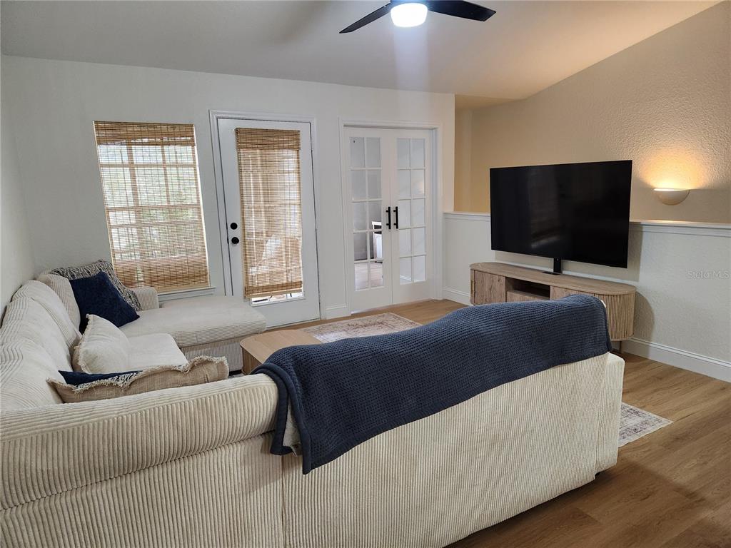 8926 Manor Loop, Unit 201B Lakewood Ranch, FL 34202 - Photo 6 of 32 a living room with furniture and a flat screen tv