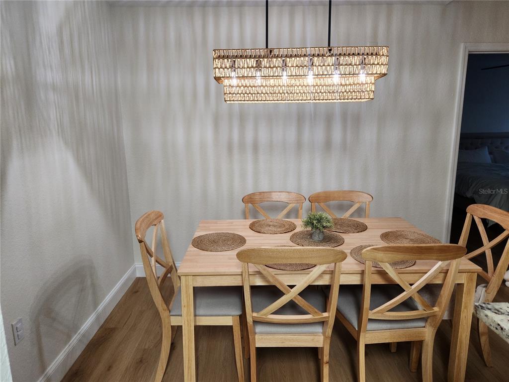 8926 Manor Loop, Unit 201B Lakewood Ranch, FL 34202 - Photo 10 of 32 a view of a dining room with furniture and window