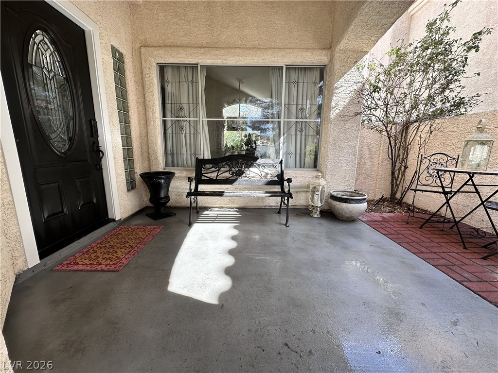 9724 Trail Rider Drive Las Vegas, NV 89117 - Photo 13 of 52 View of exterior entry featuring a patio area and stucco siding