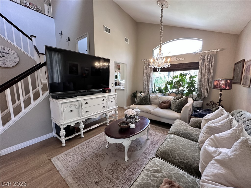 9724 Trail Rider Drive Las Vegas, NV 89117 - Photo 18 of 52 Living room with hanging lights, wood finished floors, and lofted ceiling