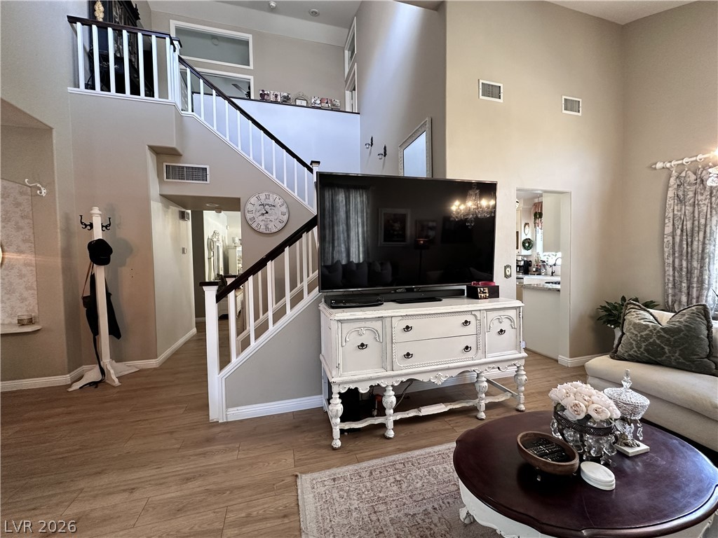 9724 Trail Rider Drive Las Vegas, NV 89117 - Photo 19 of 52 Living area featuring a high ceiling and light wood finished floors