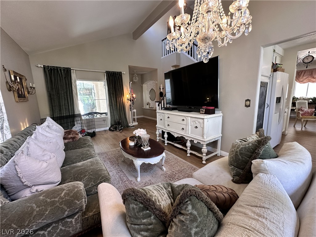 9724 Trail Rider Drive Las Vegas, NV 89117 - Photo 20 of 52 Living area with suspended lighting, wood finished floors, and vaulted ceiling