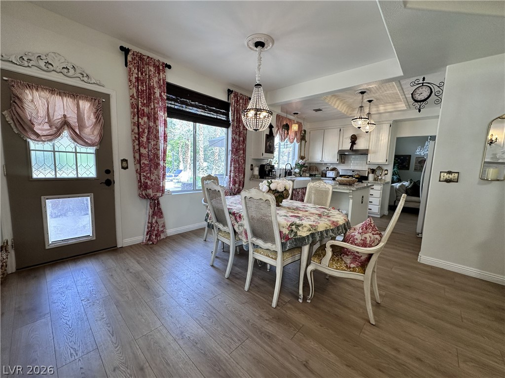 9724 Trail Rider Drive Las Vegas, NV 89117 - Photo 28 of 52 Dining space with dark wood finished floors and a chandelier