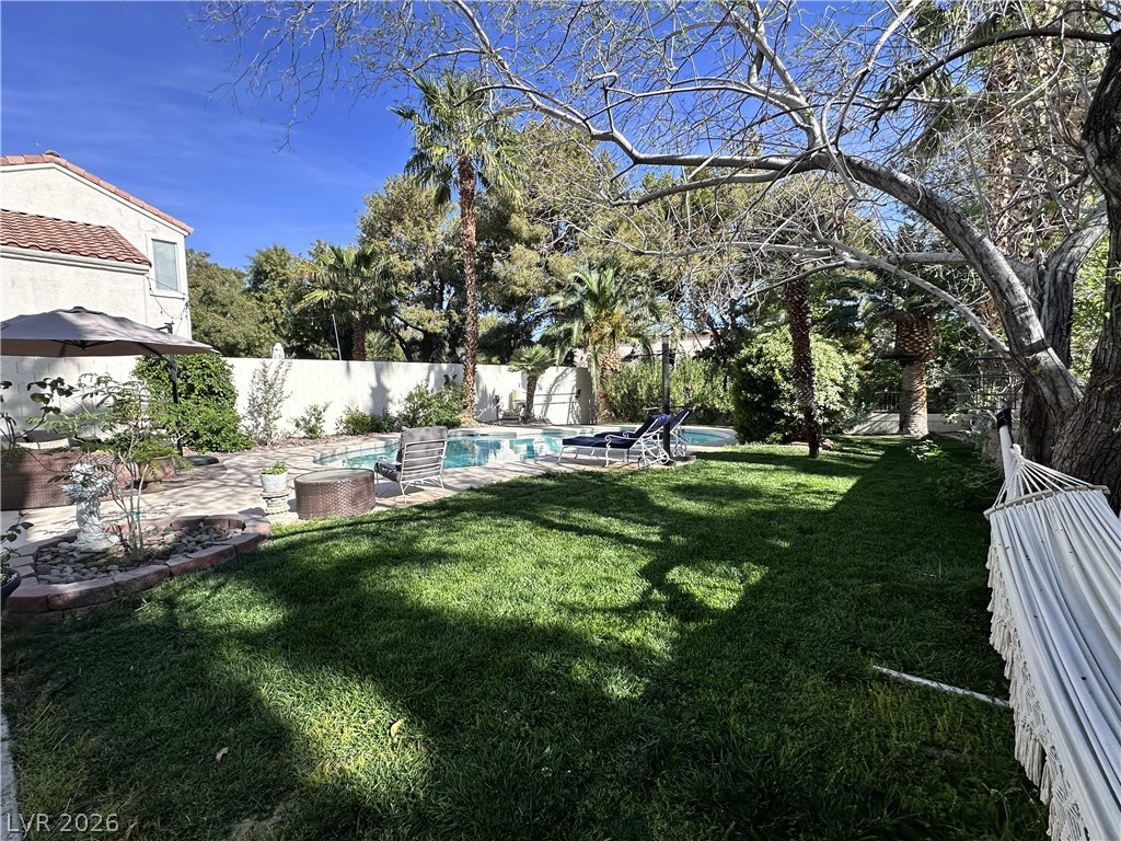 9724 Trail Rider Drive Las Vegas, NV 89117 - Photo 3 of 52 Fenced backyard featuring a patio