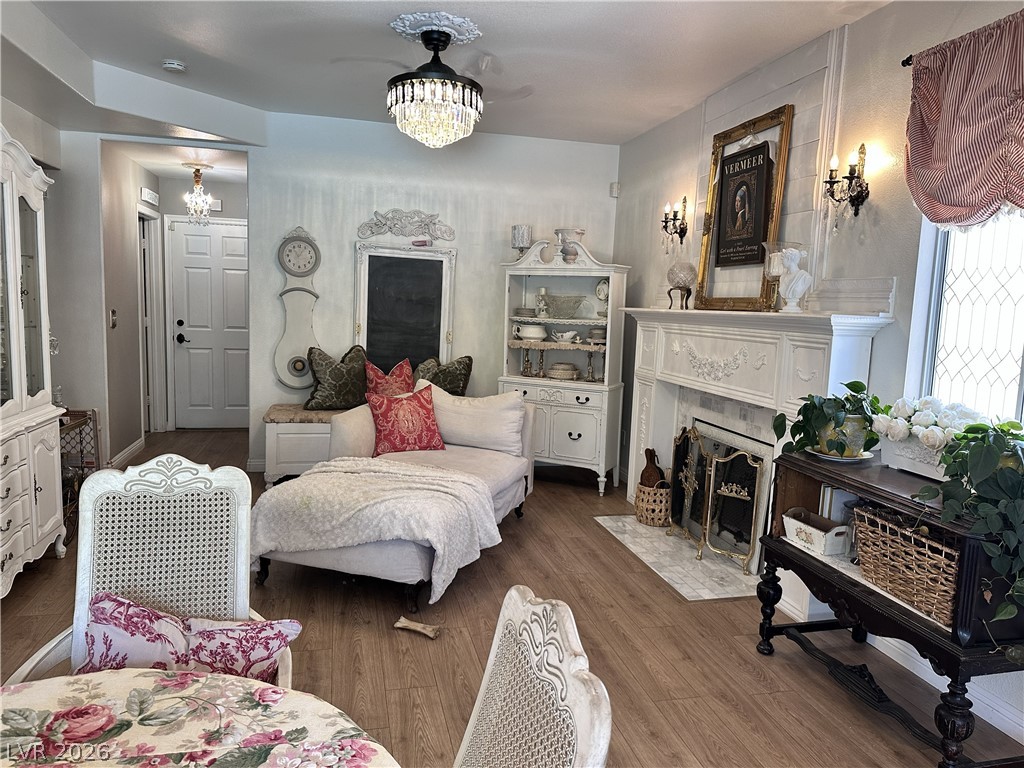 9724 Trail Rider Drive Las Vegas, NV 89117 - Photo 31 of 52 Living area featuring a chandelier, wood finished floors, and a premium fireplace