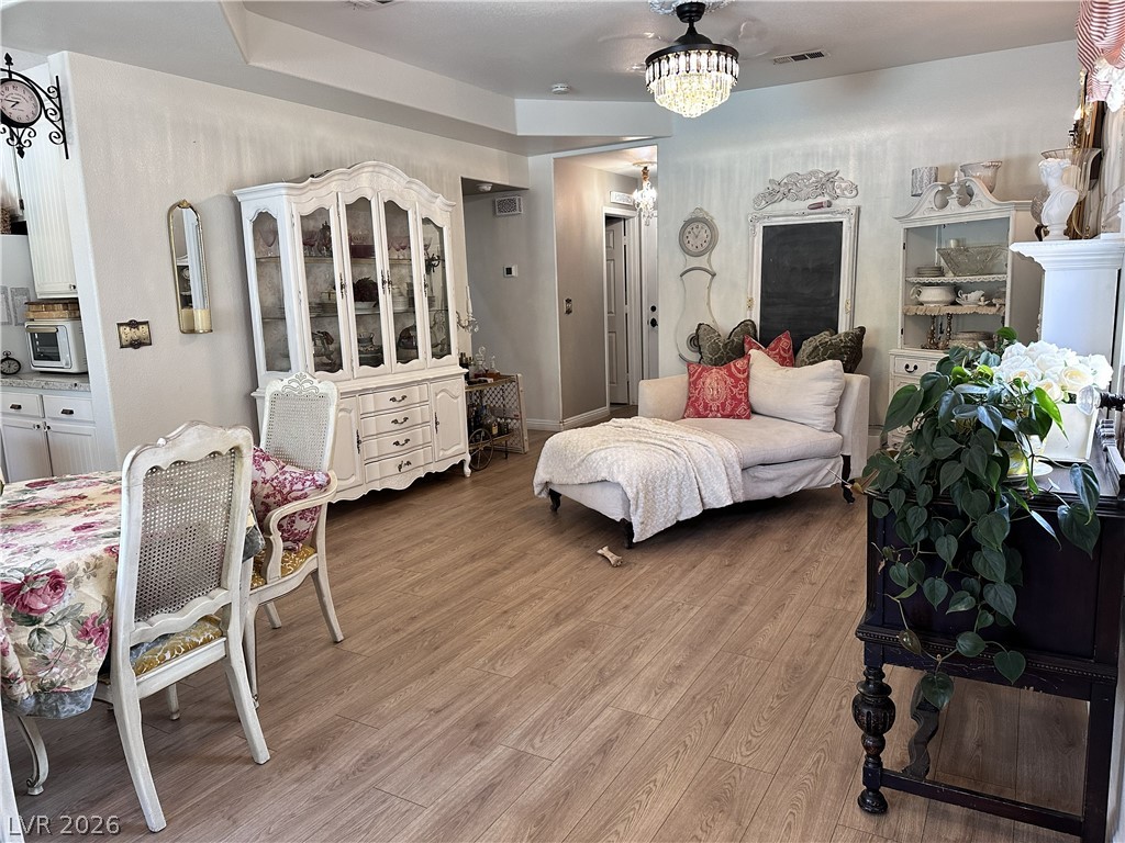 9724 Trail Rider Drive Las Vegas, NV 89117 - Photo 34 of 52 Bedroom with light wood-style floors and hanging lights