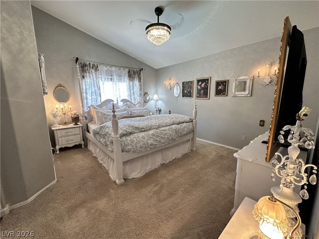 9724 Trail Rider Drive Las Vegas, NV 89117 - Photo 36 of 52 Bedroom with dark carpet and vaulted ceiling