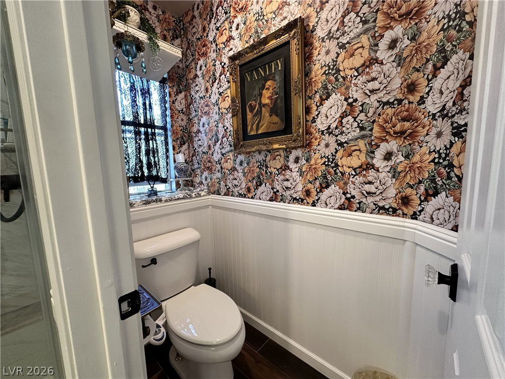 9724 Trail Rider Drive Las Vegas, NV 89117 - Photo 40 of 52 Bathroom with a wainscoted wall, wallpapered walls, and dark wood-style floors