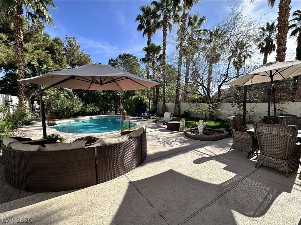 9724 Trail Rider Drive Las Vegas, NV 89117 - Photo 4 of 52 Fenced backyard featuring a patio and an outdoor living / dining area