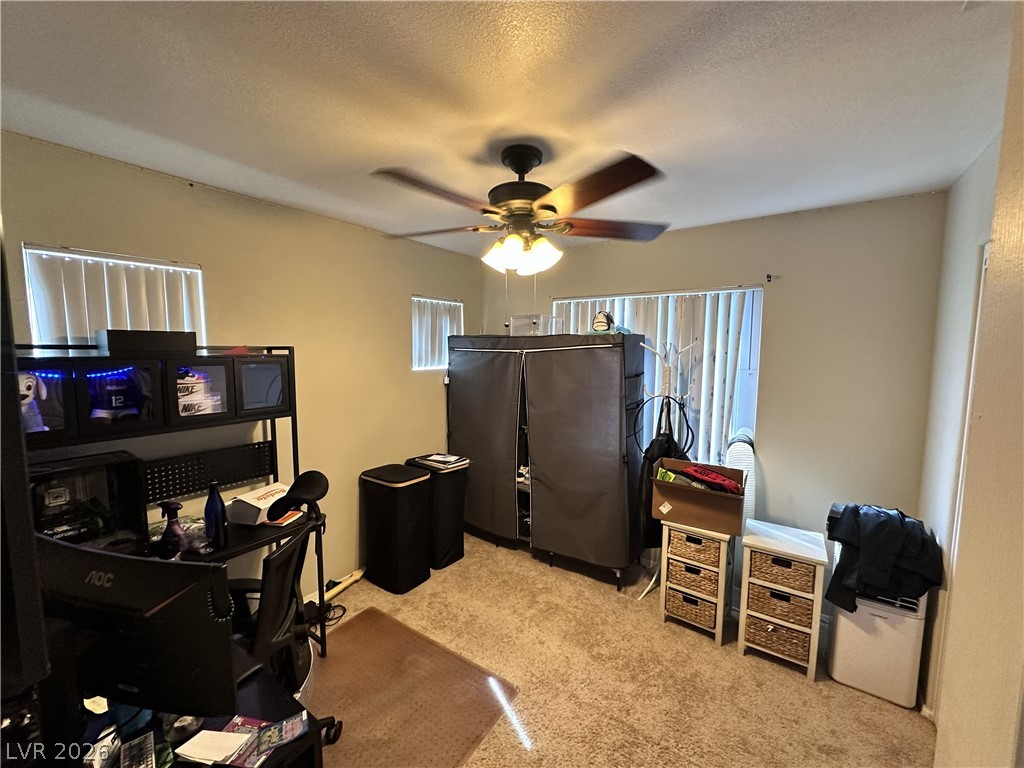 9724 Trail Rider Drive Las Vegas, NV 89117 - Photo 47 of 52 Office space featuring light colored carpet, a ceiling fan, and a textured ceiling