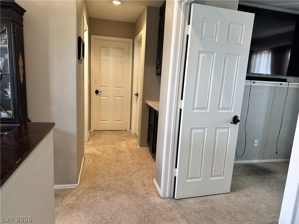 9724 Trail Rider Drive Las Vegas, NV 89117 - Photo 50 of 52 Corridor with light carpet and a textured wall