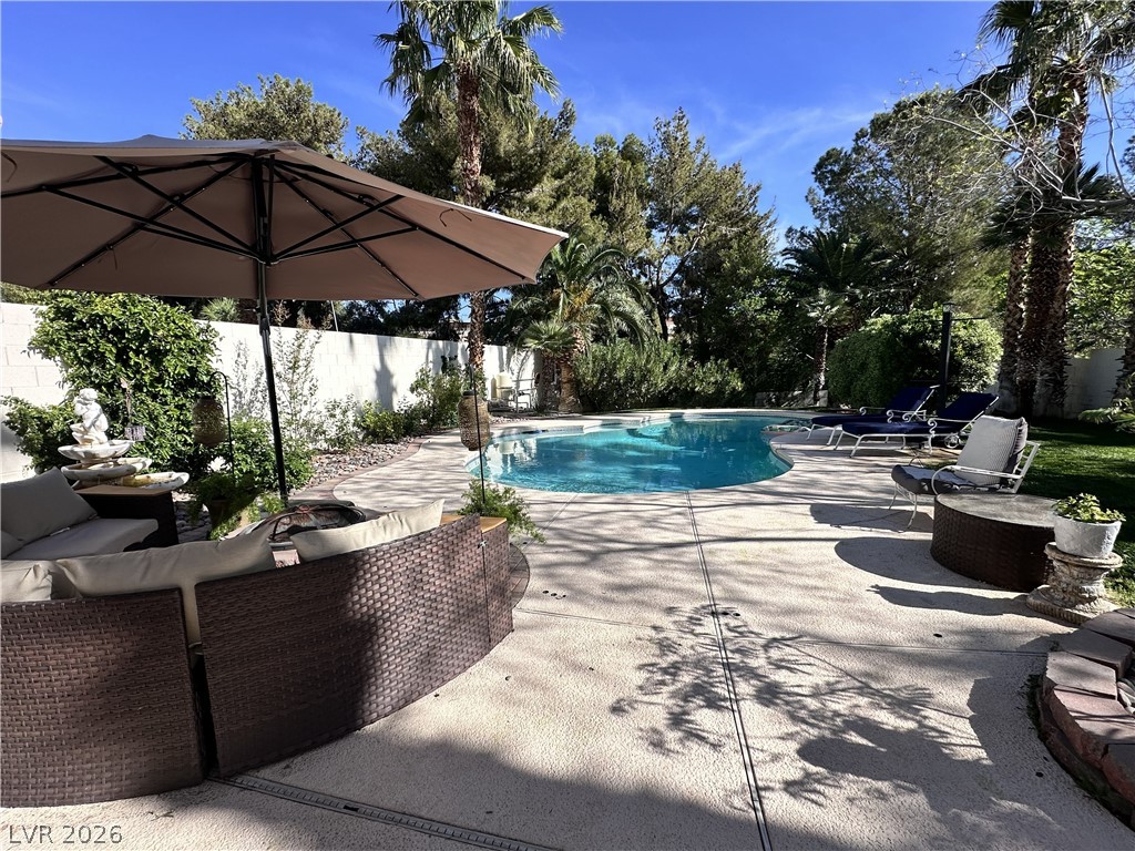 9724 Trail Rider Drive Las Vegas, NV 89117 - Photo 5 of 52 View of pool featuring patio surround, a fenced backyard, and outdoor furniture