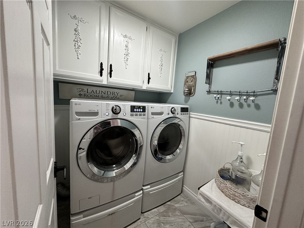 9724 Trail Rider Drive Las Vegas, NV 89117 - Photo 51 of 52 Laundry area with a wainscoted wall, cabinet space, light marble finish floors, and independent washer and dryer
