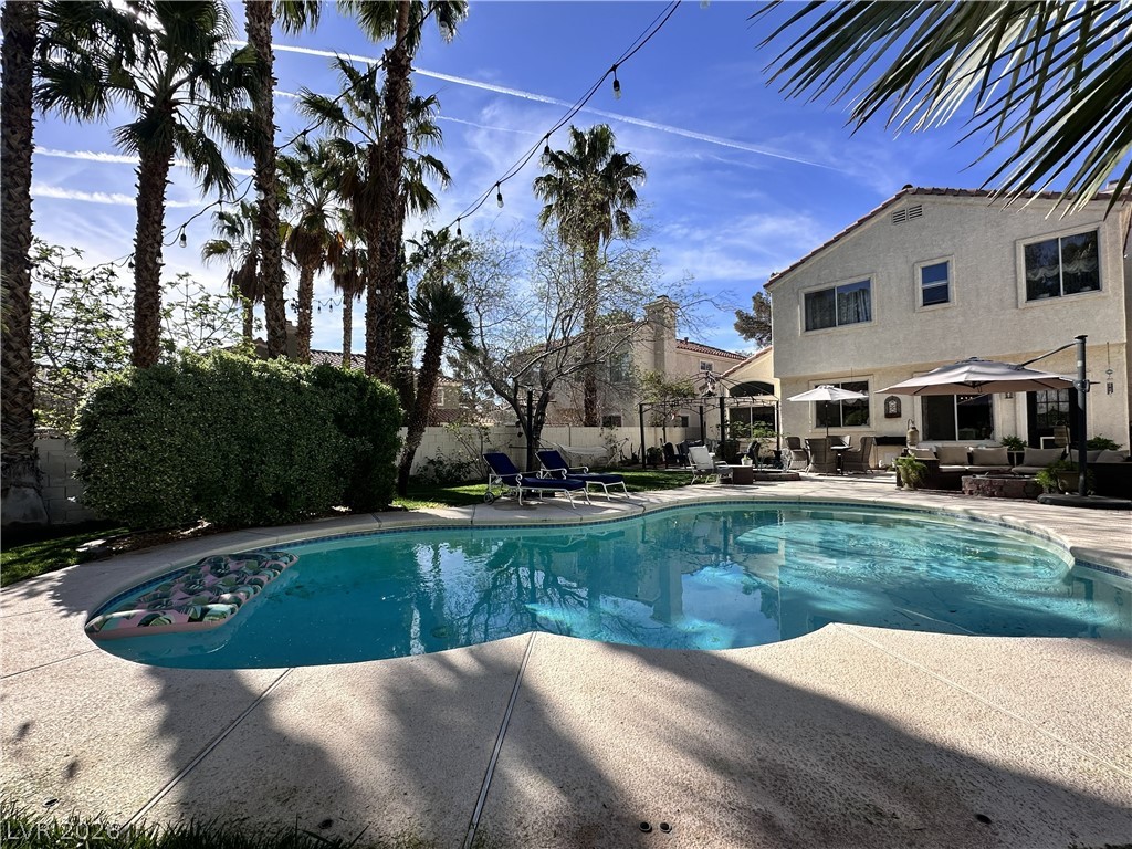 9724 Trail Rider Drive Las Vegas, NV 89117 - Photo 8 of 52 View of swimming pool featuring an outdoor lounge area, patio surround, a fenced backyard, and a gazebo