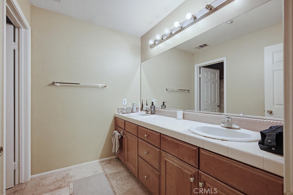 1747 Palermo Drive Riverside, CA 92507 - Photo 17 of 30 a spacious bathroom with a double vanity sink and a mirror