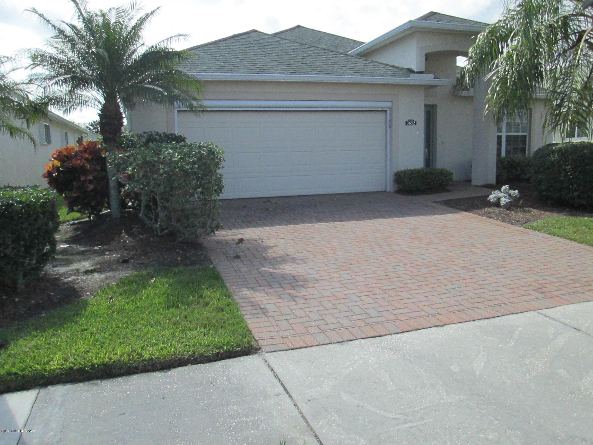 3652 Shawnee Lane Melbourne, FL 32901 - Photo 1 of 34 a front view of a house with garden