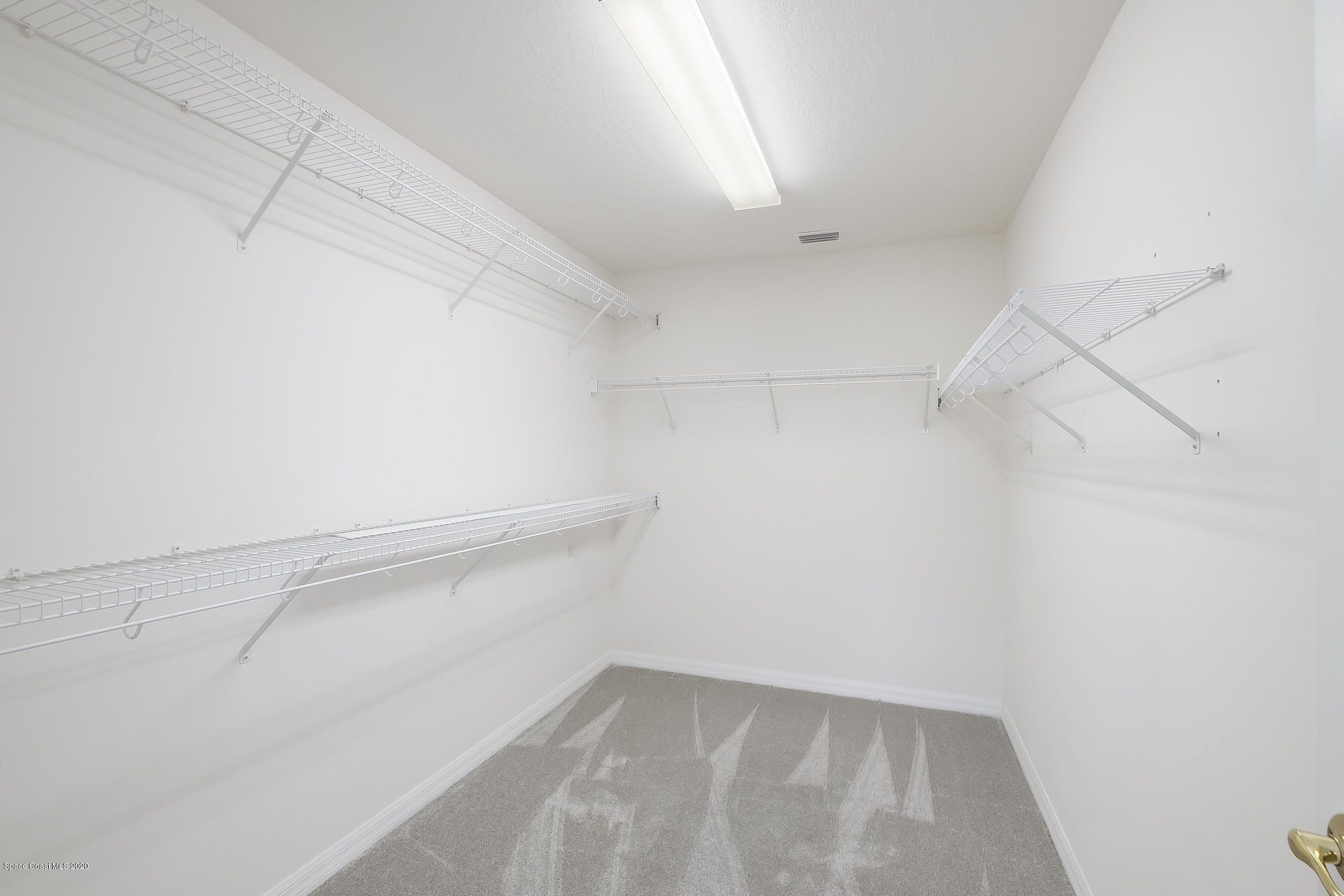 3652 Shawnee Lane Melbourne, FL 32901 - Photo 16 of 34 a view of a room with racks on the wall