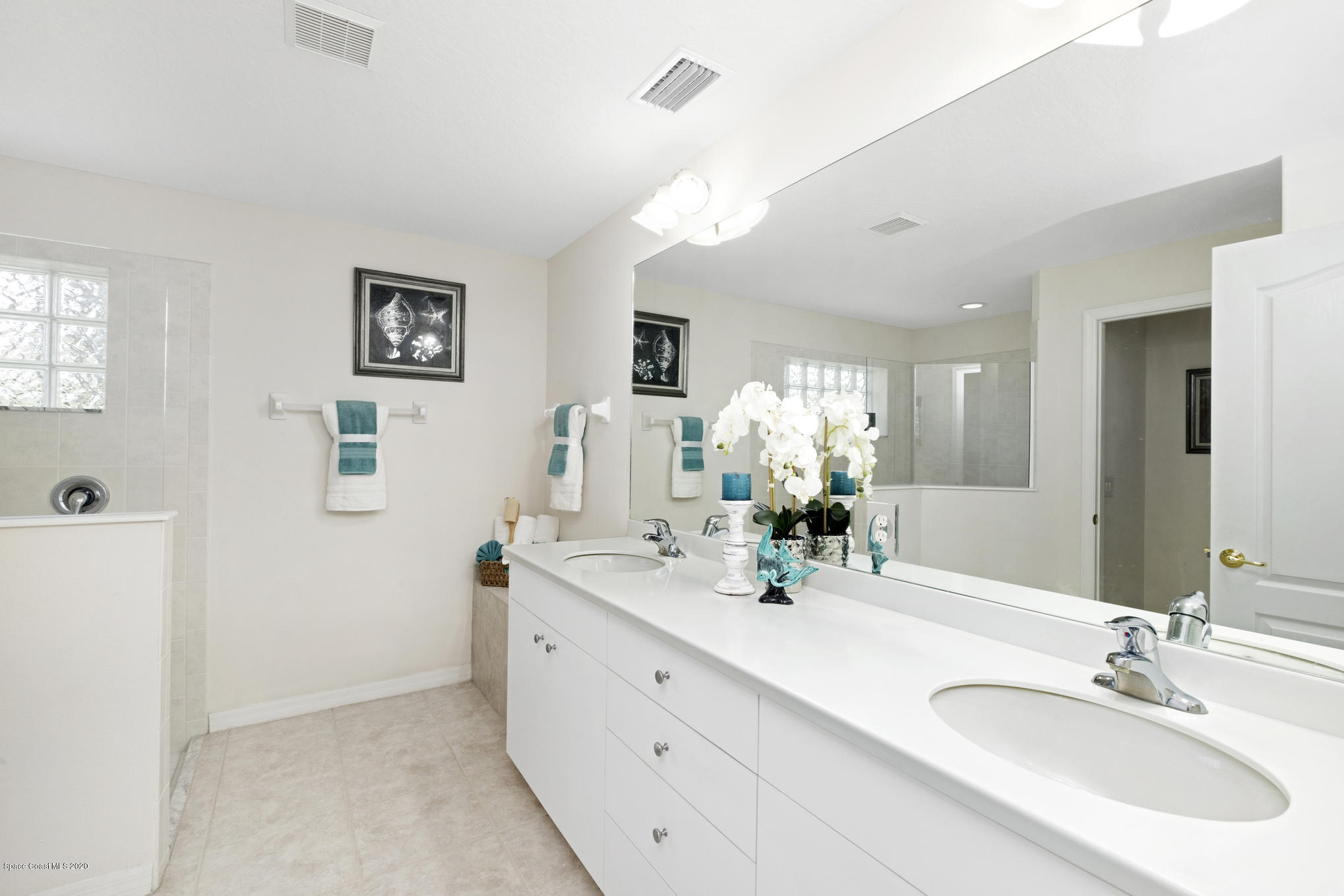 3652 Shawnee Lane Melbourne, FL 32901 - Photo 17 of 34 a bathroom with a double vanity sink and a mirror