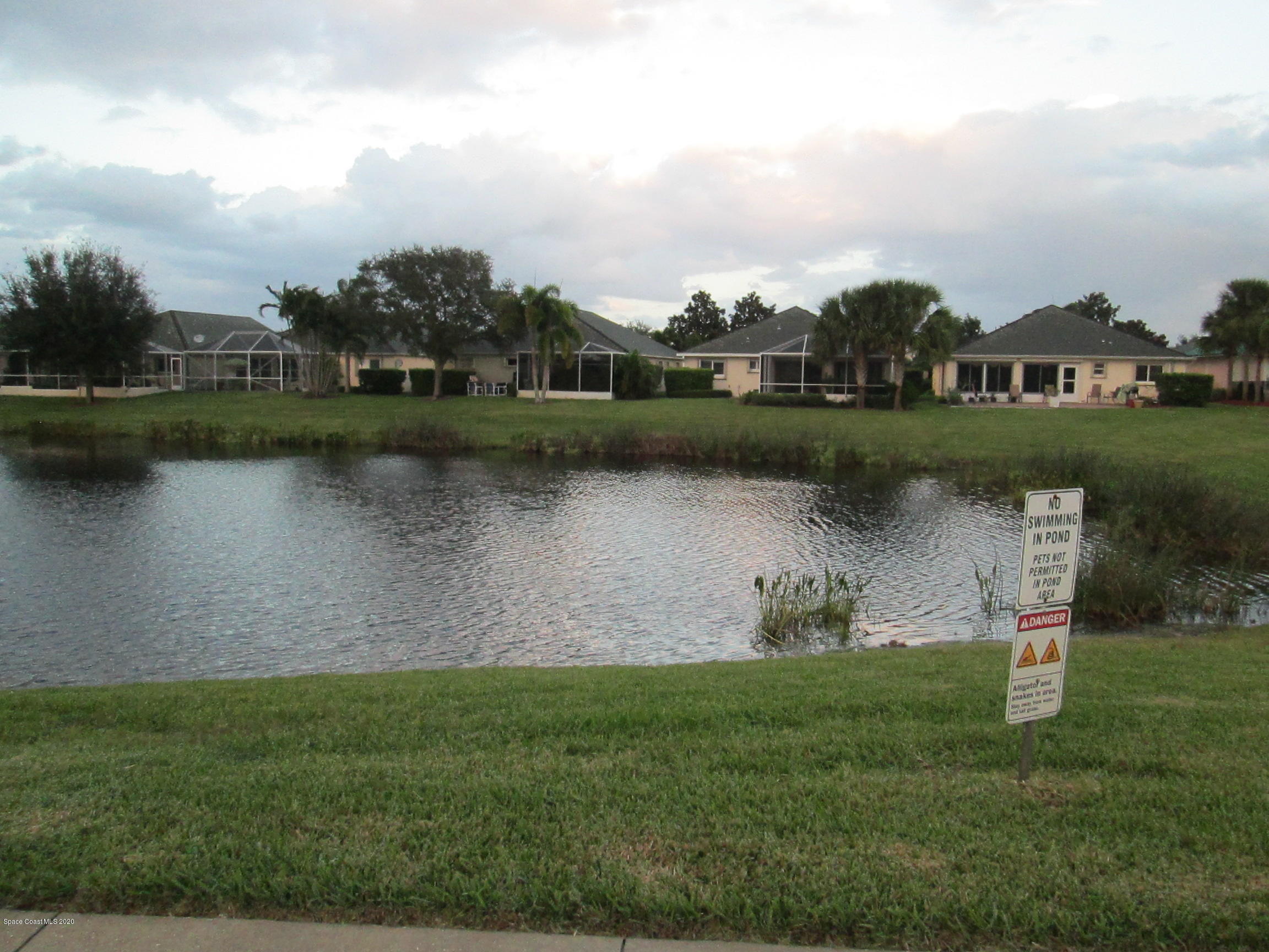 3652 Shawnee Lane Melbourne, FL 32901 - Photo 25 of 34 an outdoor view of a lake with houses in the back