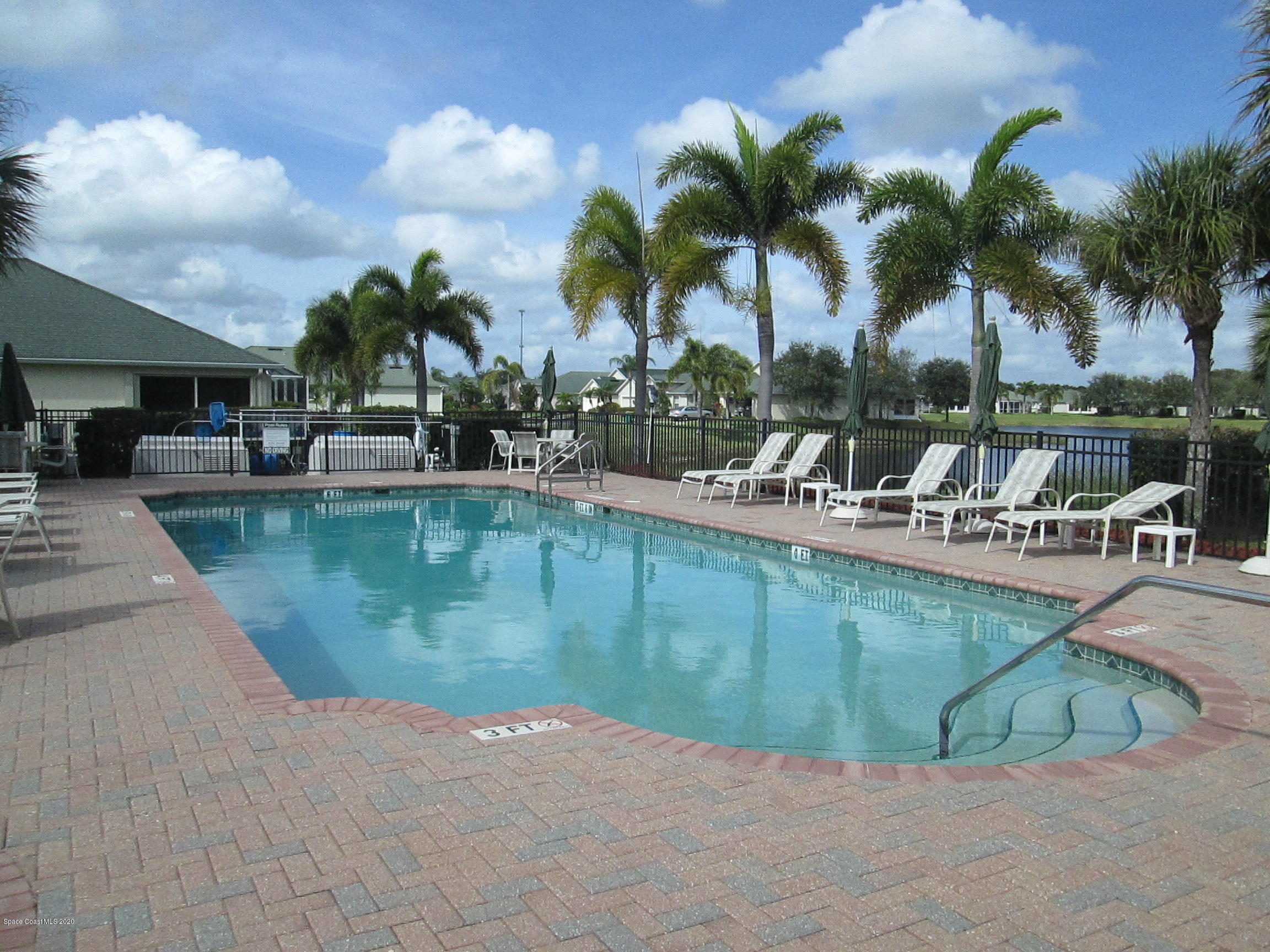 3652 Shawnee Lane Melbourne, FL 32901 - Photo 29 of 34 a view of a swimming pool with lounge chairs
