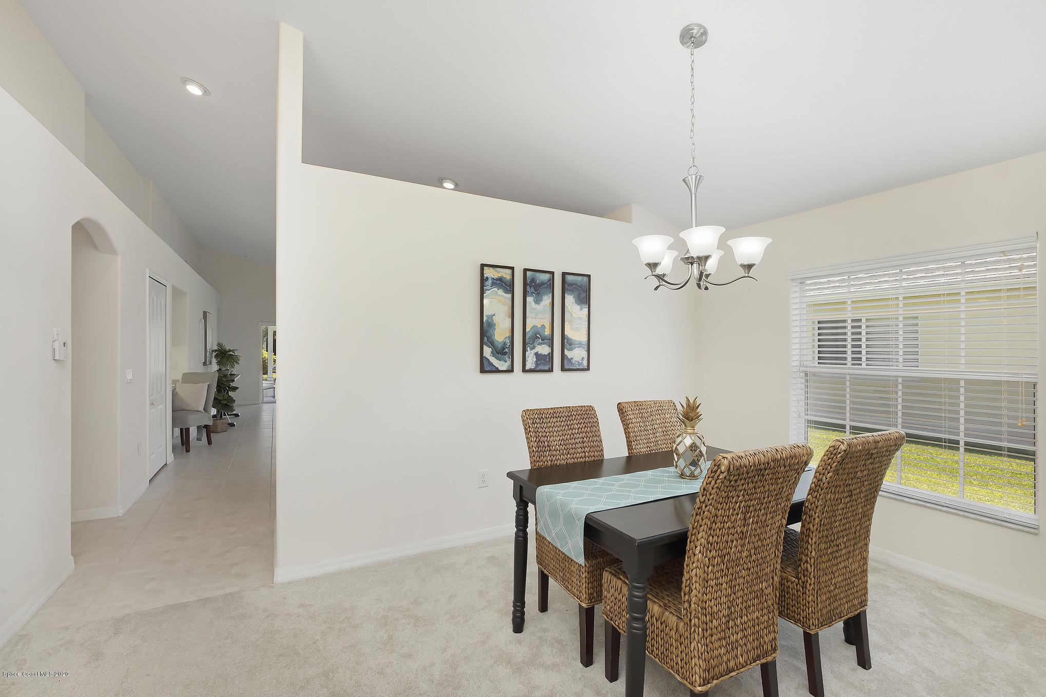 3652 Shawnee Lane Melbourne, FL 32901 - Photo 6 of 34 a view of a dining room with furniture and a chandelier fan