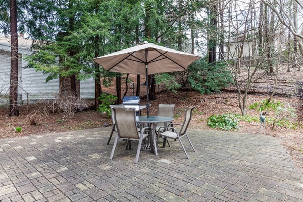 92 Varick Road Newton, MA 02468 - Photo 22 of 24 a view of a table and chairs in backyard under a umbrella