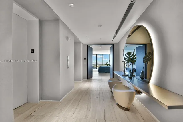 a view of a hallway with wooden floor and a potted plant