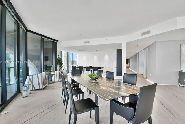 a kitchen with a table chairs stove and cabinets