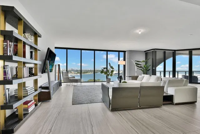 a living room with furniture and a table with wooden floor