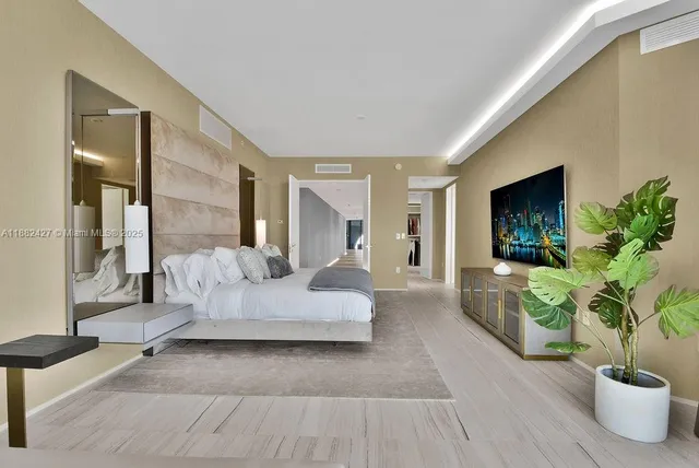 a living room with large window and furniture