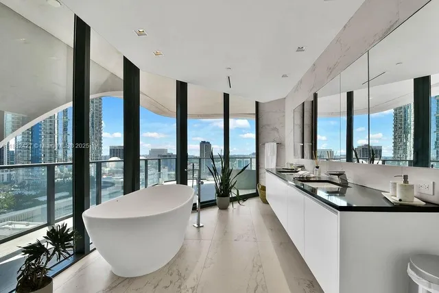 a living room with furniture and large windows