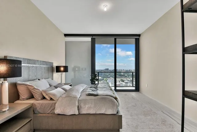 a bedroom with a bed and a lamp on table