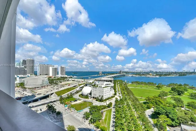 a dining room with wooden floor a chandelier