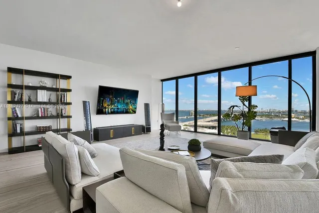 a view of living room filled with furniture and a potted plant