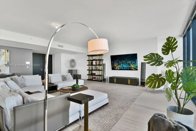 a living room with furniture and a potted plant