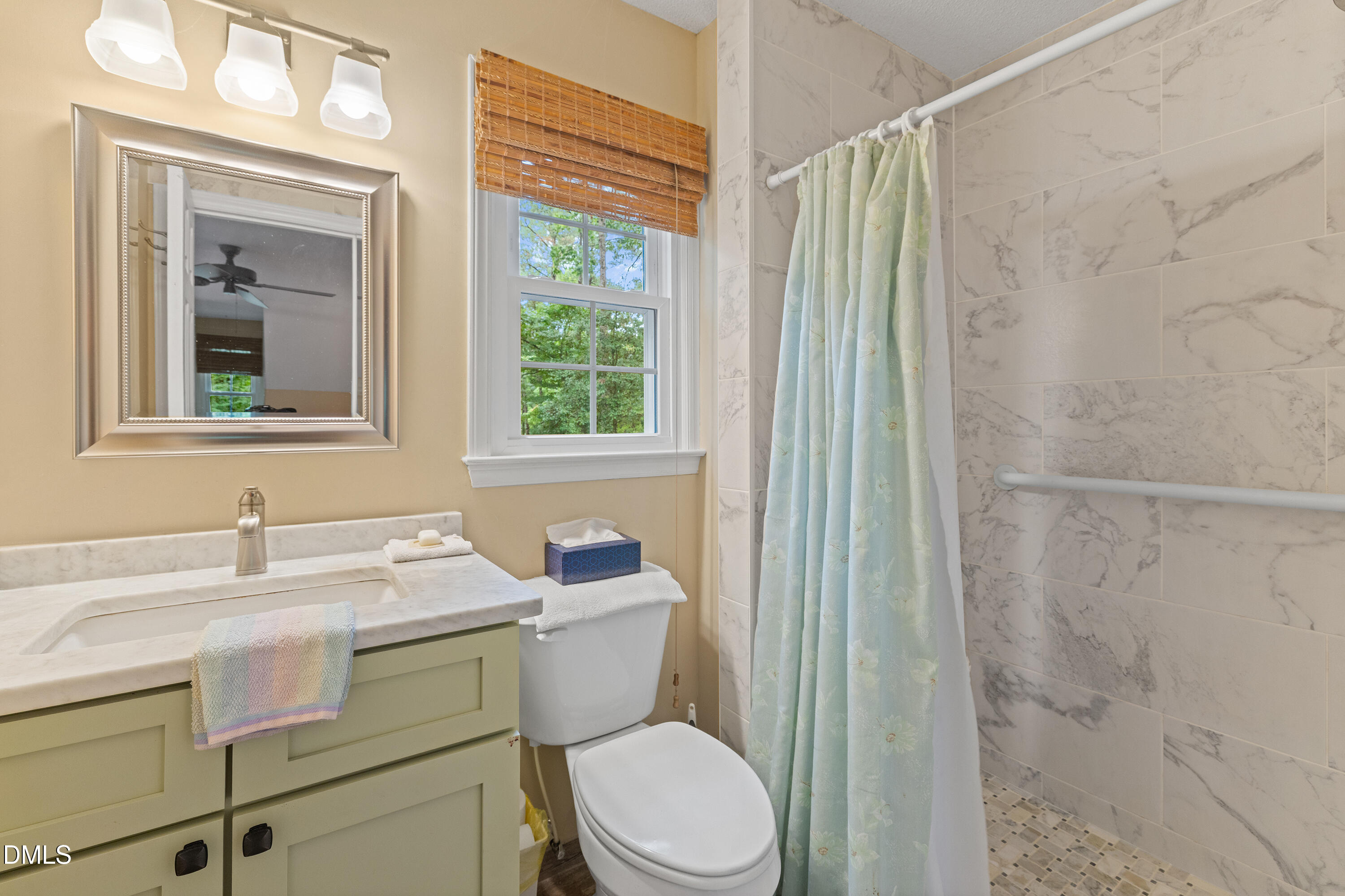 5216 Bridget Drive Raleigh, NC 27603 - Photo 17 of 30 a bathroom with a sink toilet a mirror and shower