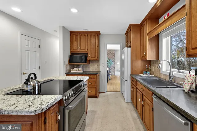 a view of a hallway with wooden floor and stairs