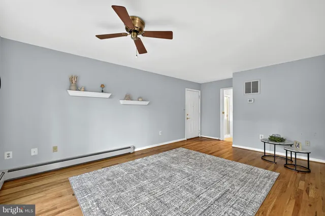 a spacious en suite bathroom with double sink and a mirror