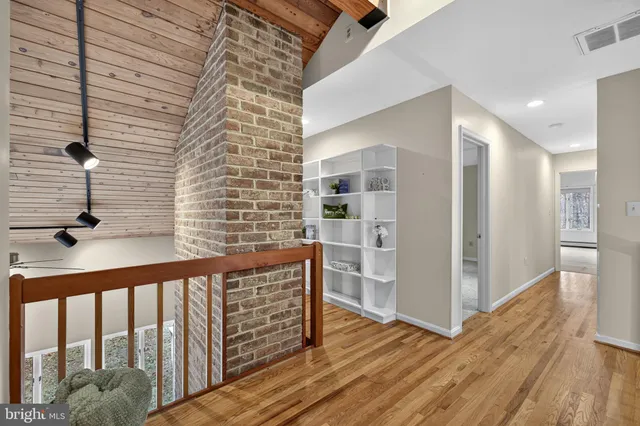 a view of a room with wooden ceiling