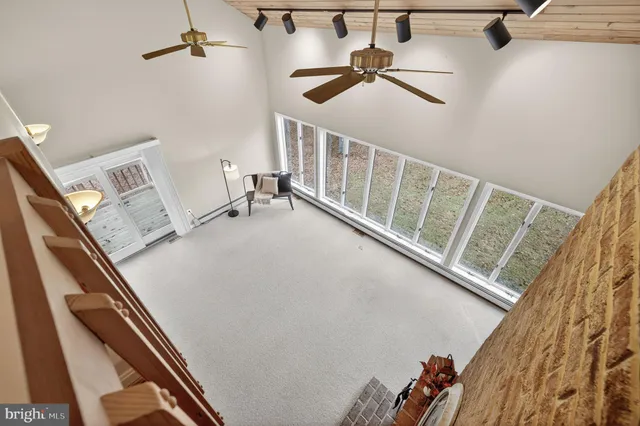 a view of balcony with wooden floor and fence