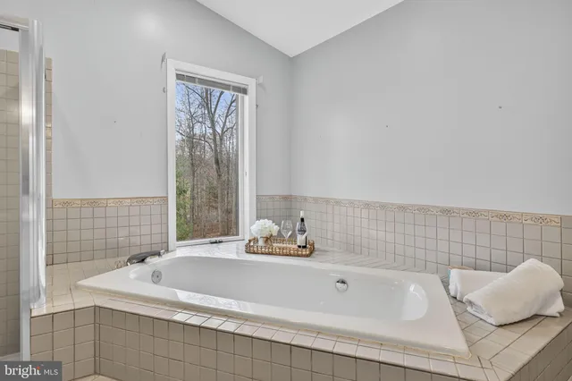 a view of a house with a yard and wooden deck