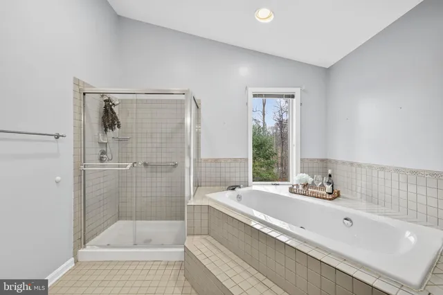 a view of a white house with a large window and wooden fence